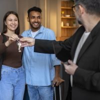 medium-shot-couple-receiving-keys